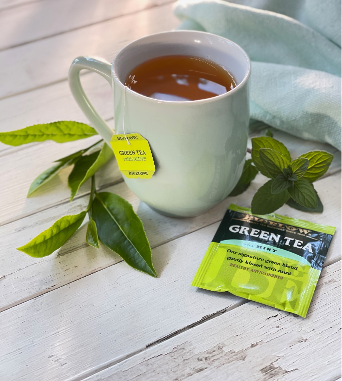 Bigelow Green Tea with Mint, mug on table with green tea bag and mint leaves